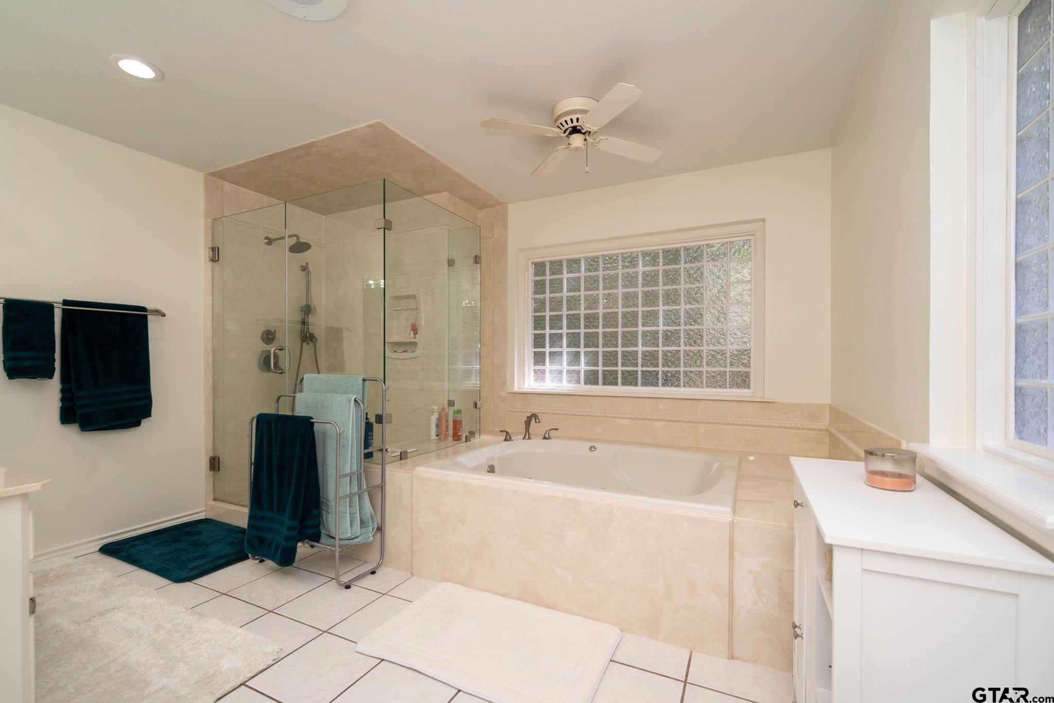 431 Gifford Street Rusk, TX 75785 - Photo 42 of 48 a bathroom with a tub a double vanity sink a mirror and shower