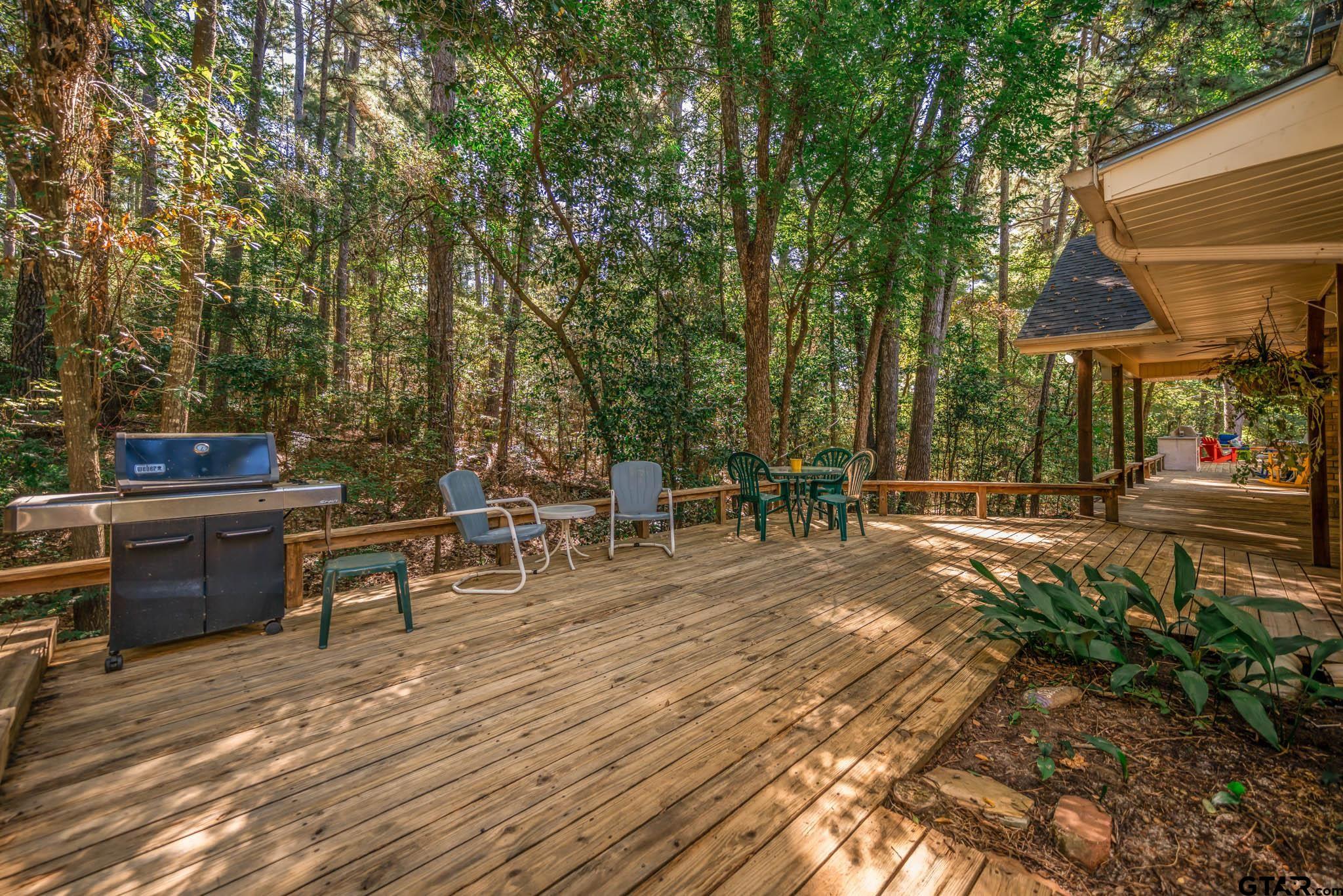 431 Gifford Street Rusk, TX 75785 - Photo 44 of 48 a view of a patio with table and chairs potted plants and large tree