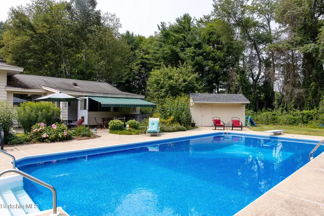 a front view of house with yard and outdoor seating