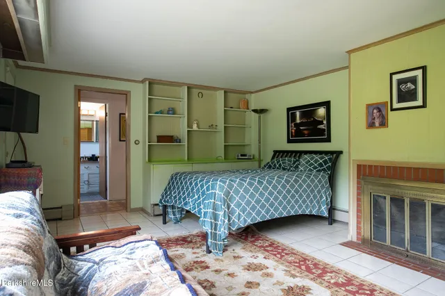 a bedroom with a bed and a television