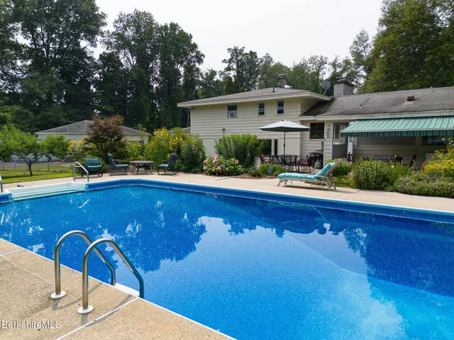 a front view of house with outdoor seating and yard