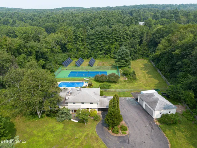 an aerial view of a house with pool outdoor seating and yard