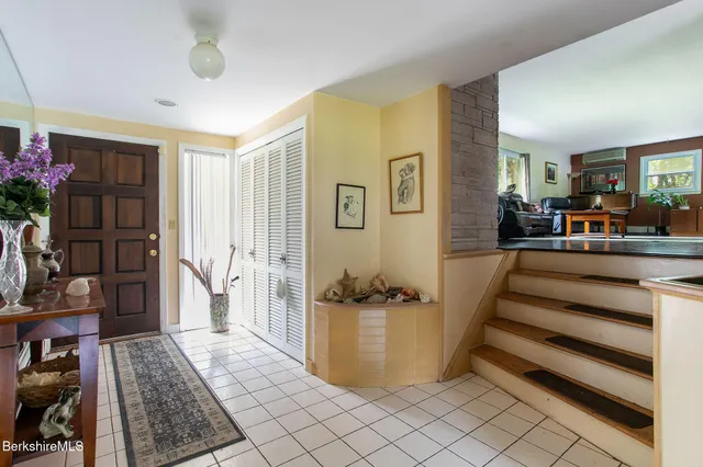 a view of living room filled with furniture and a rug