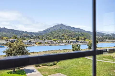 an aerial view of lake and residential houses with outdoor space