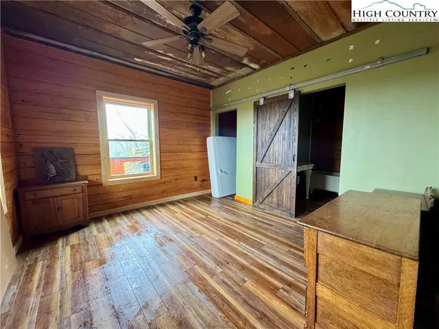 a bedroom with a bed and a television