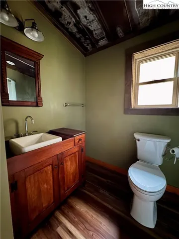 a bathroom with a toilet sink and mirror