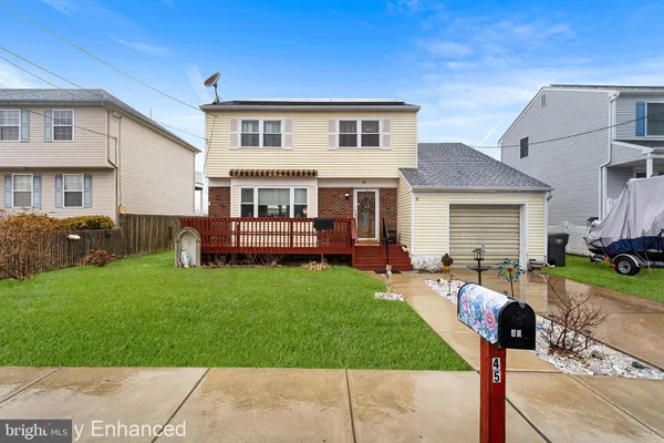 a front view of house with yard and outdoor seating