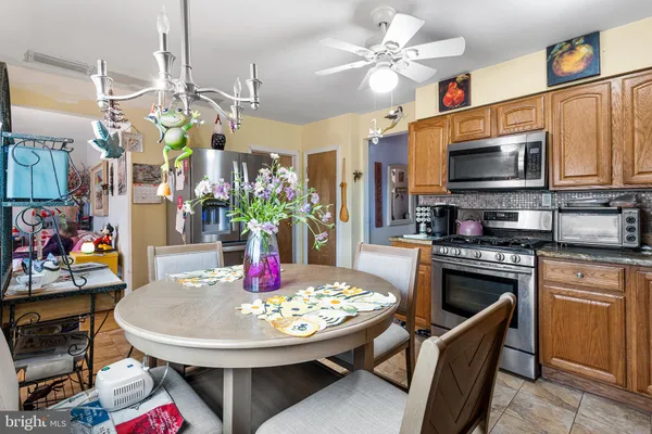 a view of a dining room with furniture and a kitchen