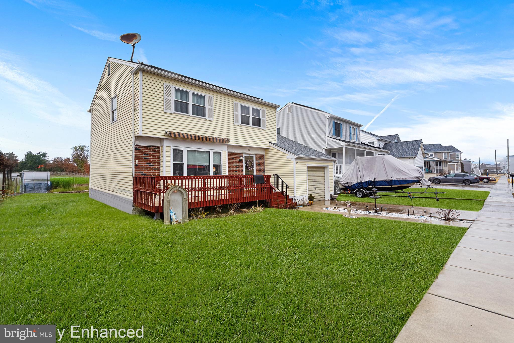 45 Heald Road Brigantine, NJ 08203 - Photo 2 of 25 a view of a house with a big yard and large trees