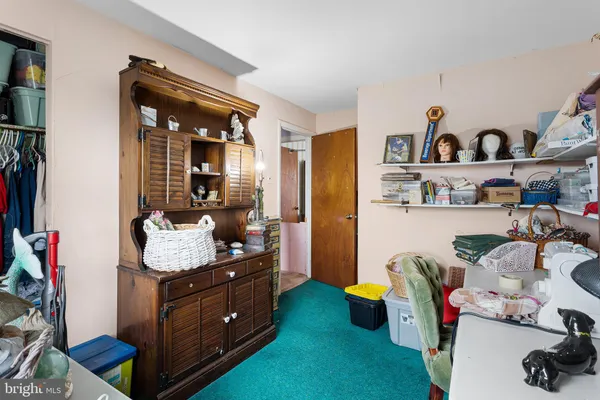 a living room with furniture and cabinets