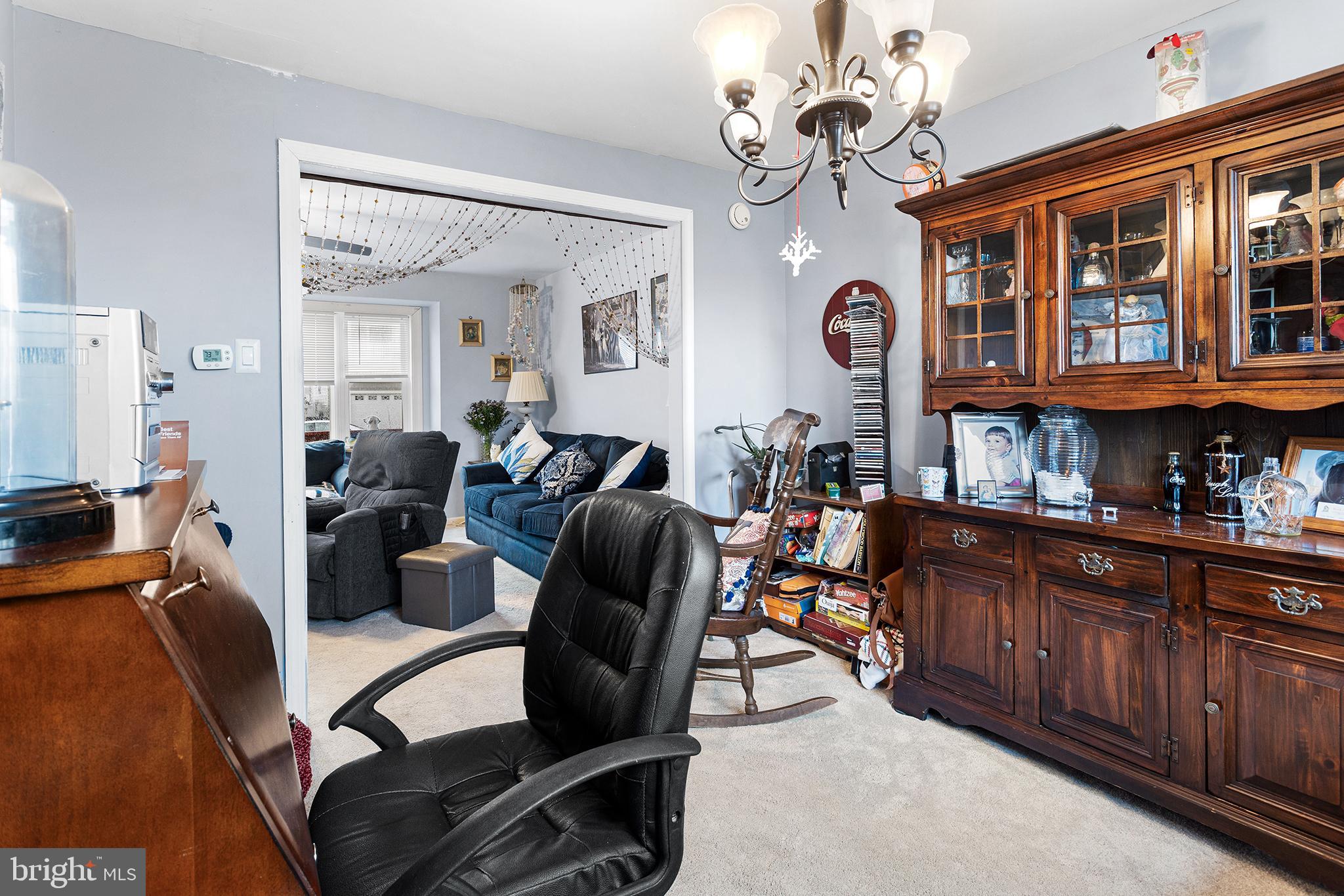 45 Heald Road Brigantine, NJ 08203 - Photo 9 of 25 a living room with furniture a chandelier and a dining table