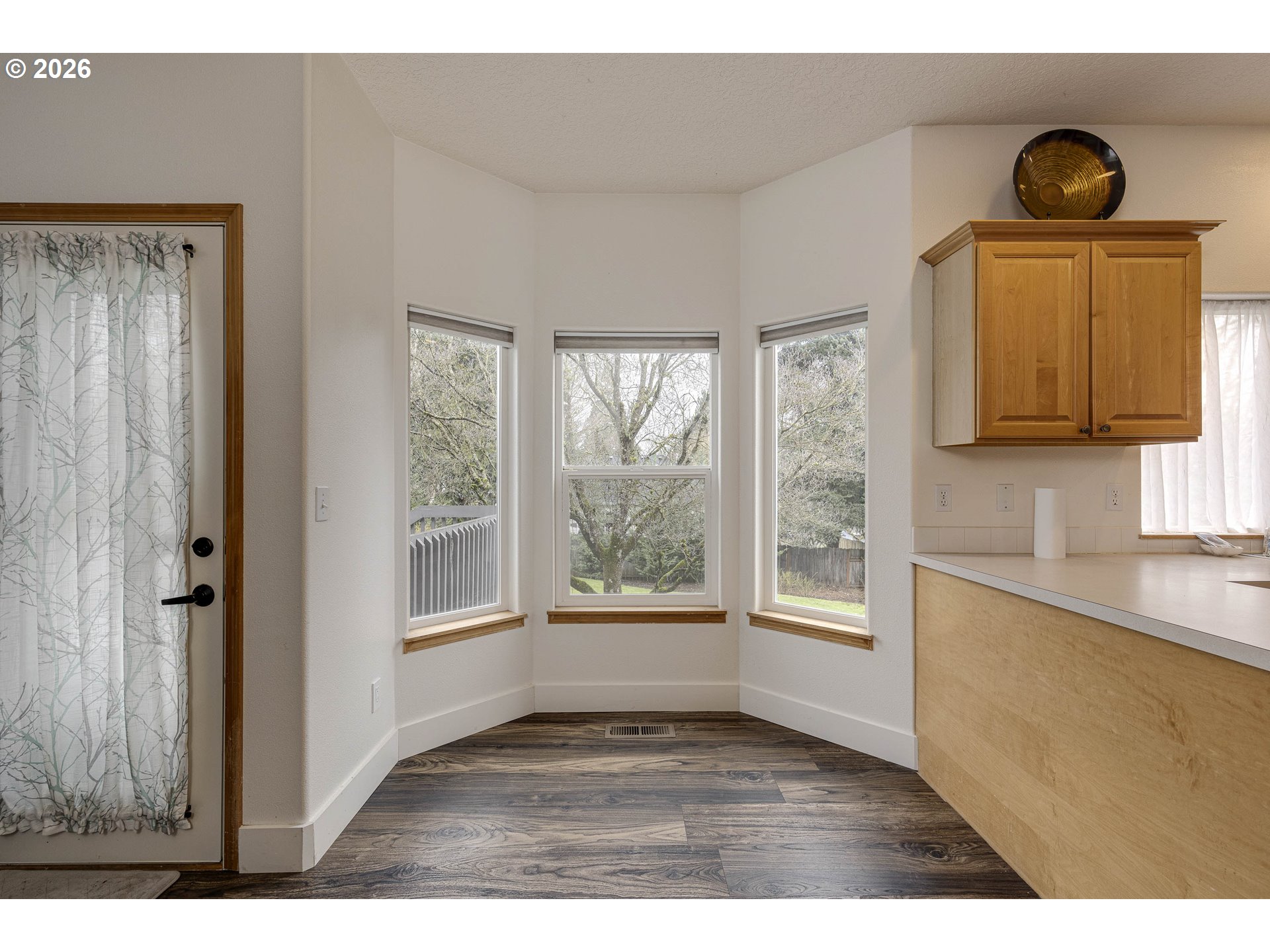 165 Northwest Peach Street Dundee, OR 97115 - Photo 15 of 35 a view of an empty room with a window and wooden floor
