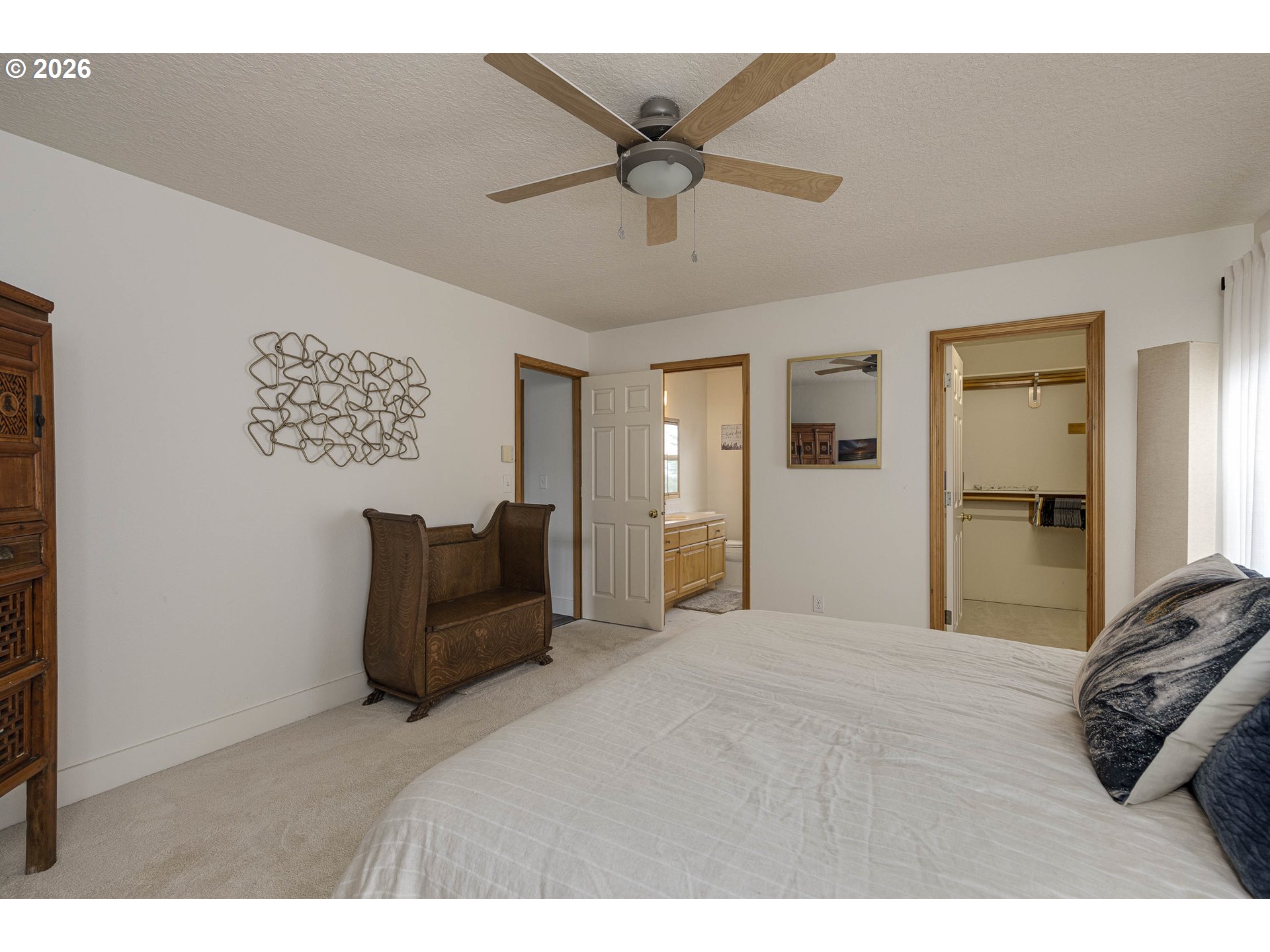 165 Northwest Peach Street Dundee, OR 97115 - Photo 22 of 35 a bedroom with a bed and a chandelier