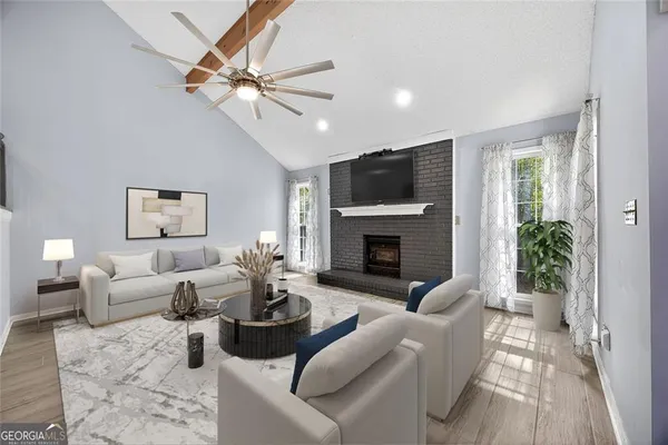 a living room with furniture a fireplace and a flat screen tv