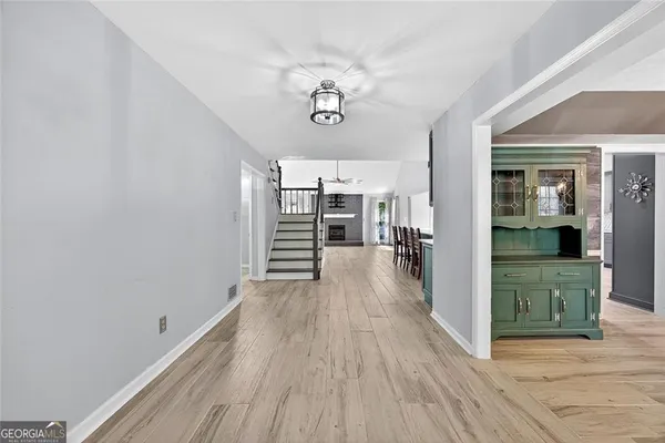 a view of a room with wooden floor