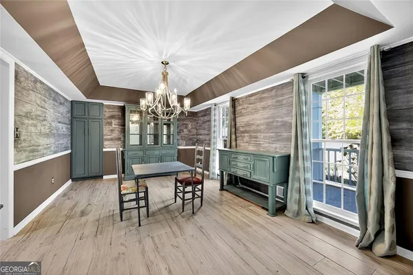 a dining room with furniture and wooden floor