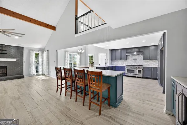 a large kitchen with a table and chairs