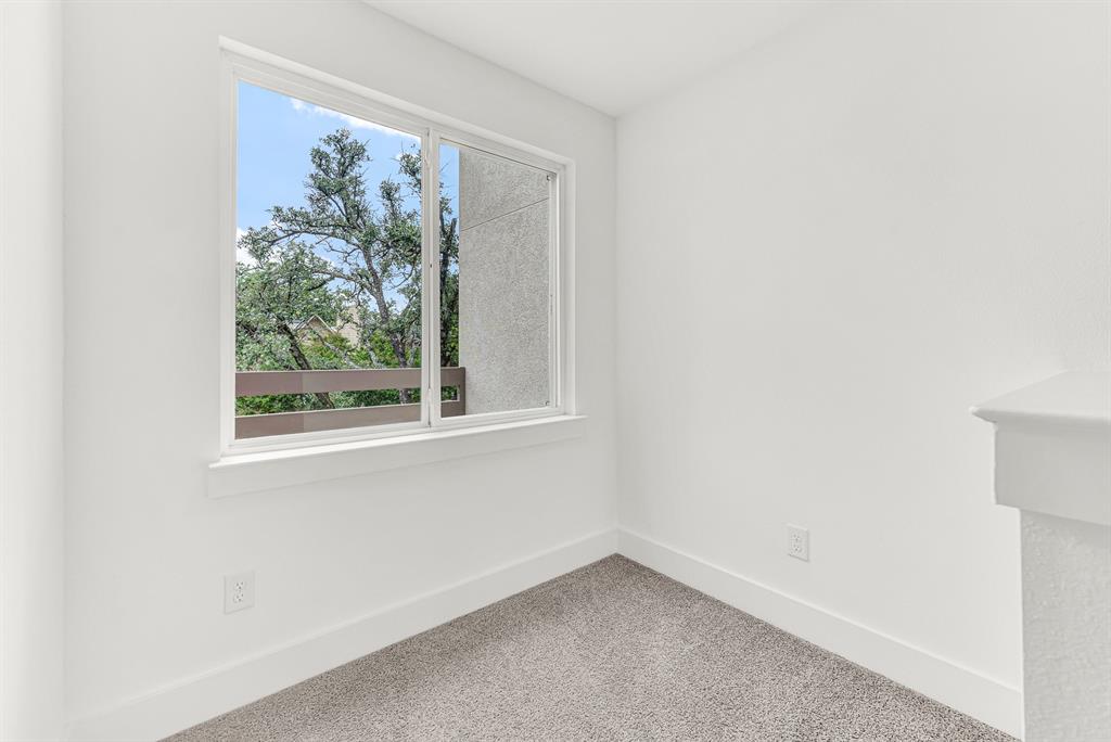 9471 Timberleaf Drive Dallas, TX 75243 - Photo 27 of 39 Bright interior space featuring a large window, white trim, and light gray carpet
