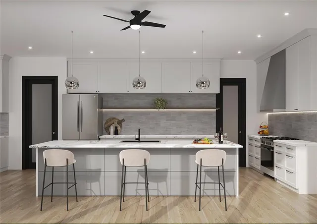 a kitchen with stainless steel appliances kitchen island granite countertop a sink and cabinets