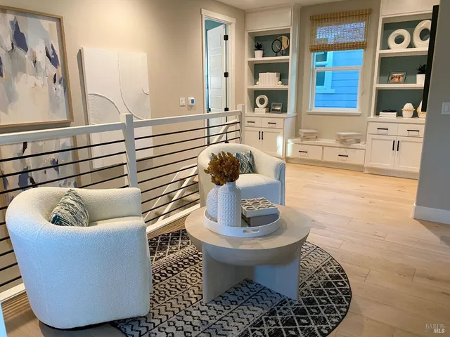 a living room with furniture and a potted plant