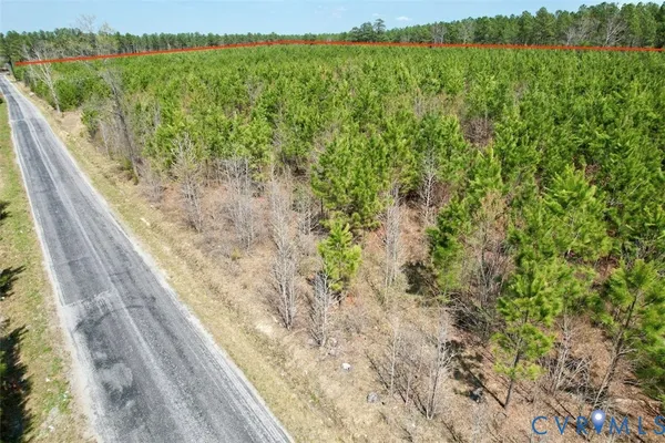 a view of a yard with a wooden fence
