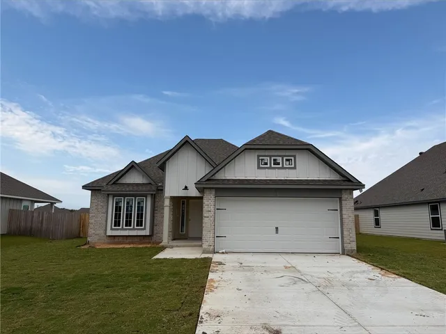 a view of a house with a yard and garage