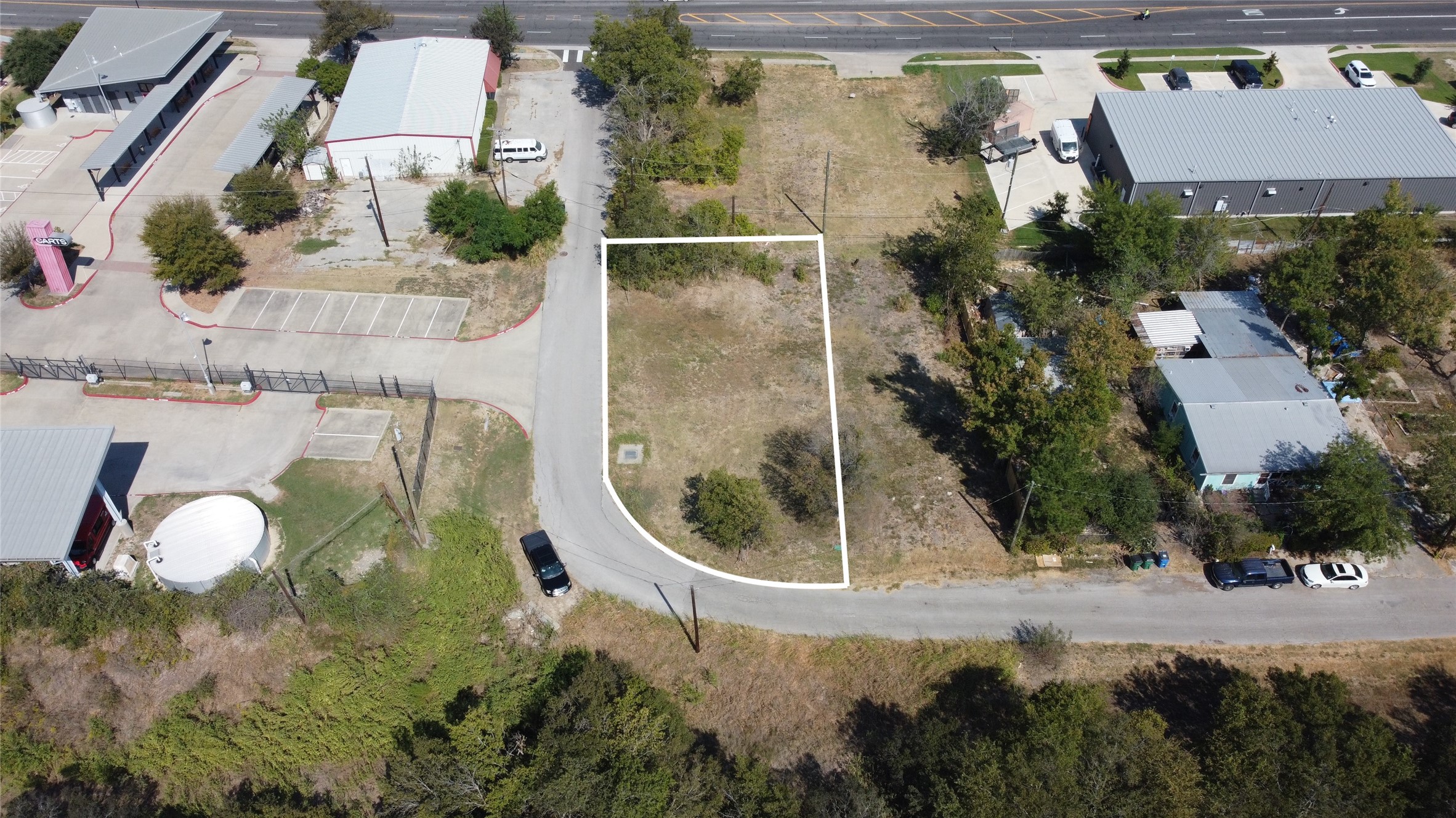 1018 West 1st Street Taylor, TX 76574 - Photo 12 of 17 an aerial view of a house with a yard and tennis court