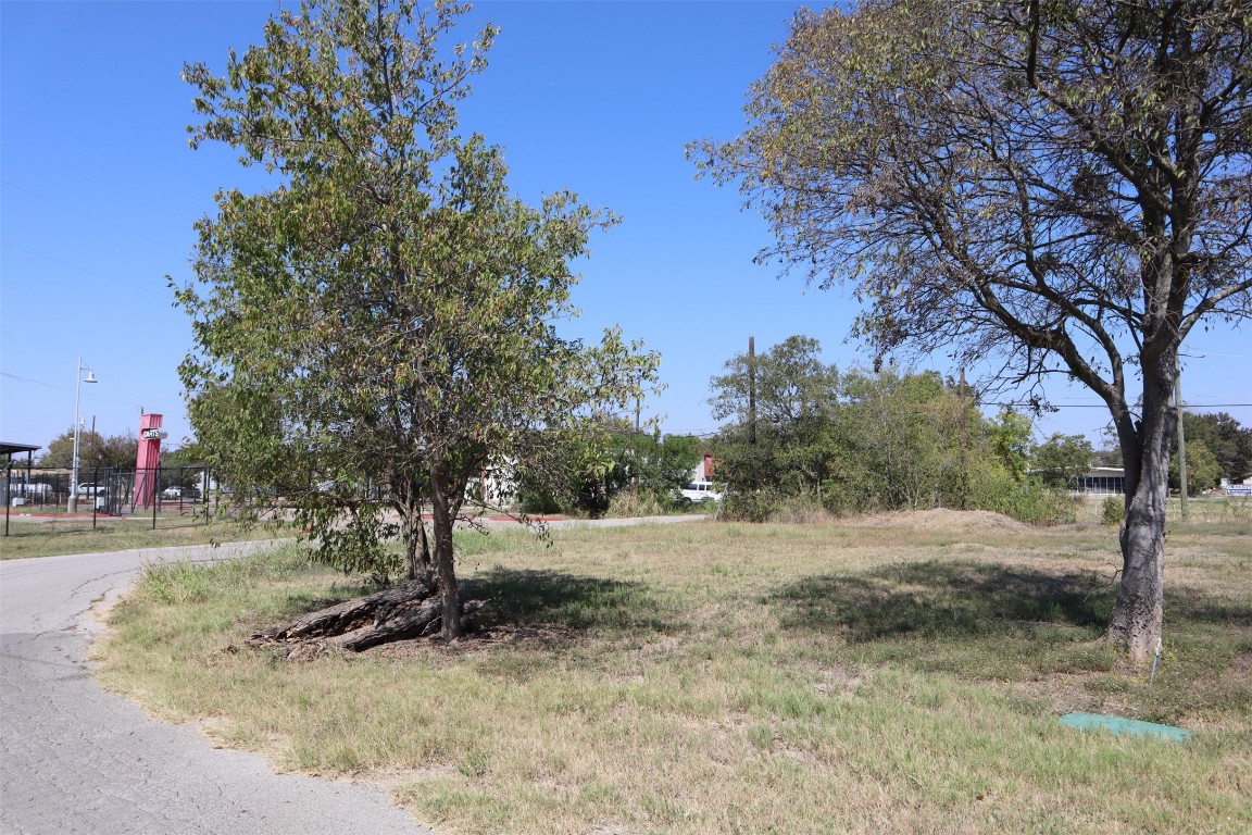 1018 West 1st Street Taylor, TX 76574 - Photo 10 of 17 a view of dirt yard with a tree