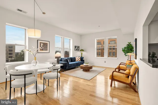 a living room with furniture fireplace and a table