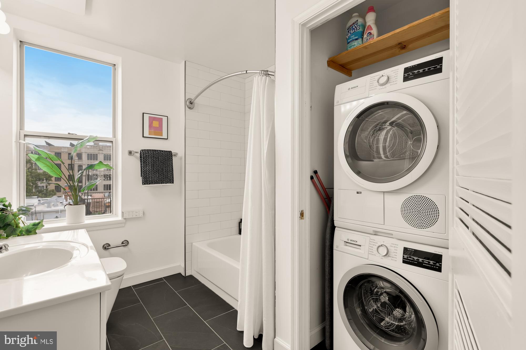 1619 R Street Northwest, Unit 606 Washington, DC 20009 - Photo 16 of 25 a view of a bedroom with washer and dryer
