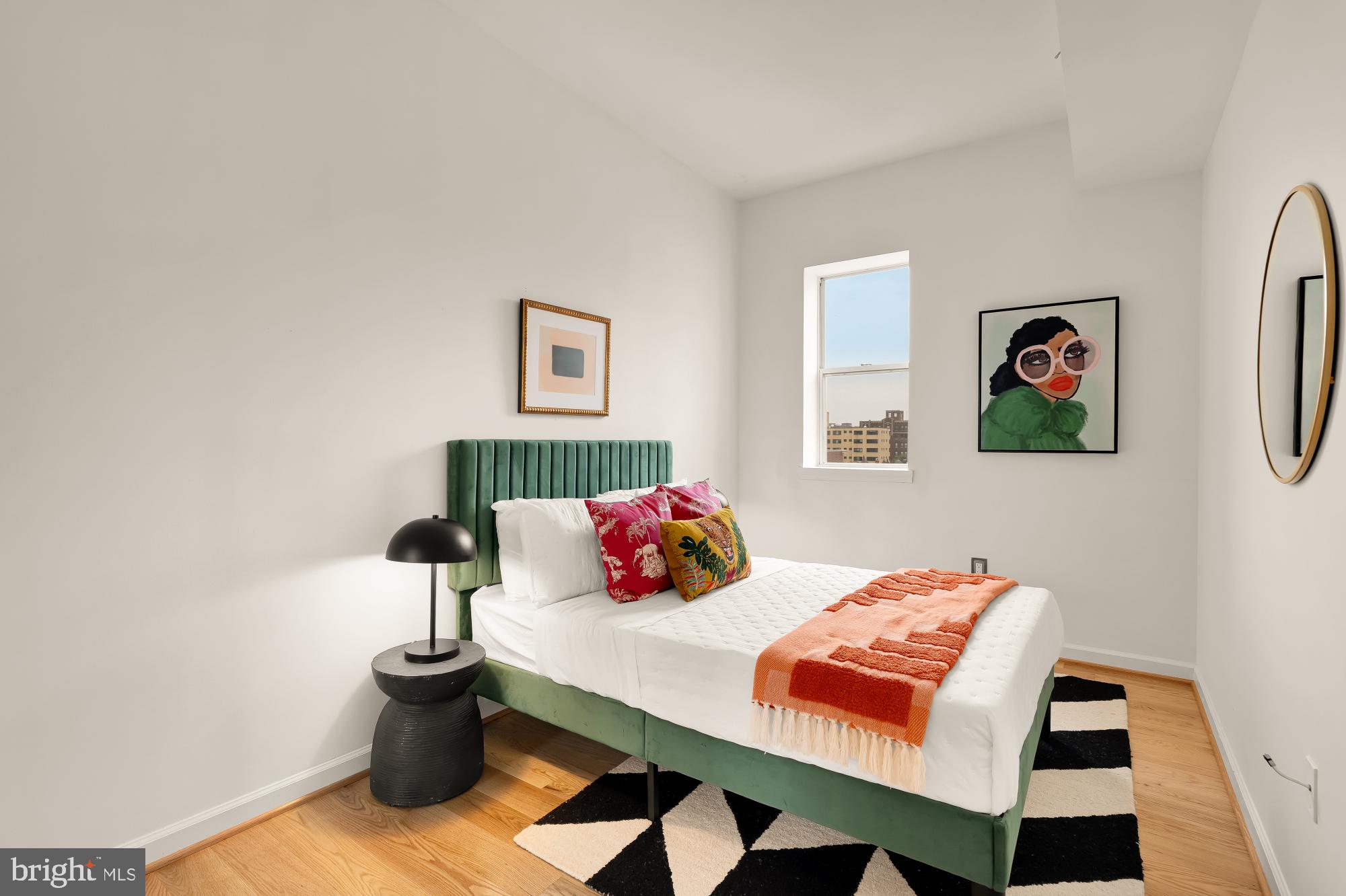 1619 R Street Northwest, Unit 606 Washington, DC 20009 - Photo 17 of 25 a bedroom with a bed and wooden floor