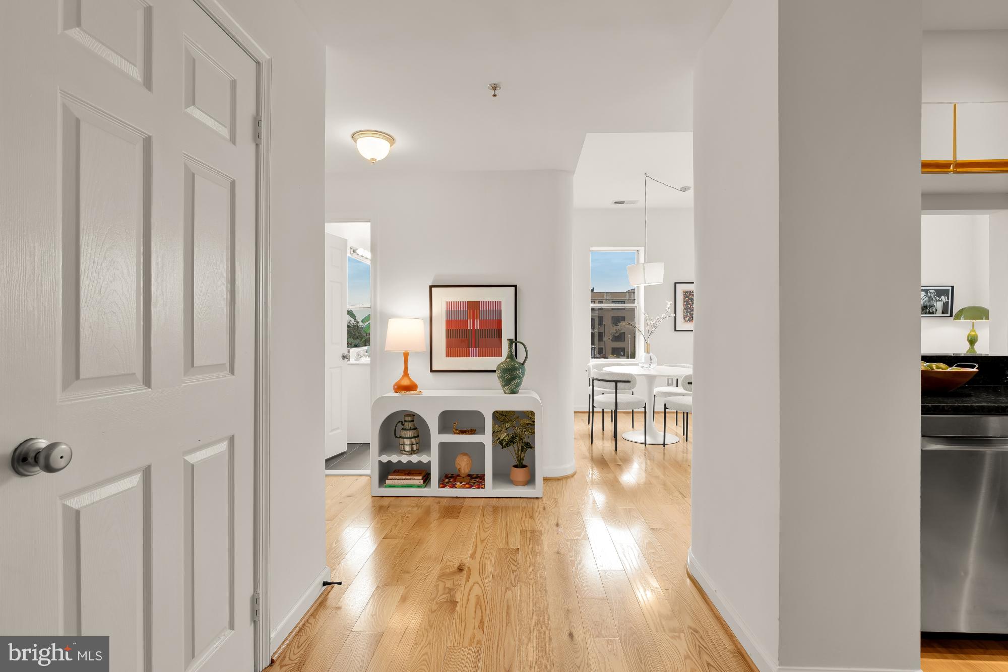1619 R Street Northwest, Unit 606 Washington, DC 20009 - Photo 2 of 25 a view of a hallway with wooden floor and furniture