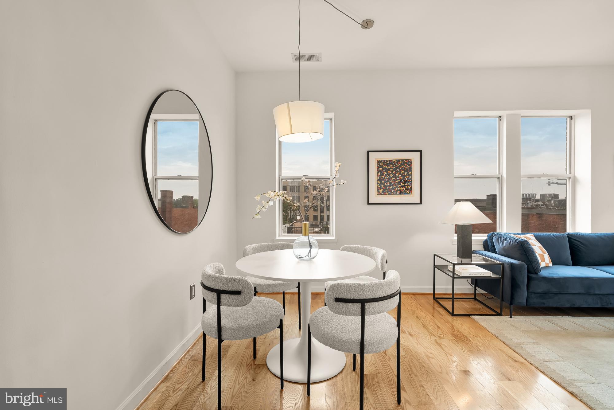 1619 R Street Northwest, Unit 606 Washington, DC 20009 - Photo 3 of 25 a dining room with chandelier and a mirror