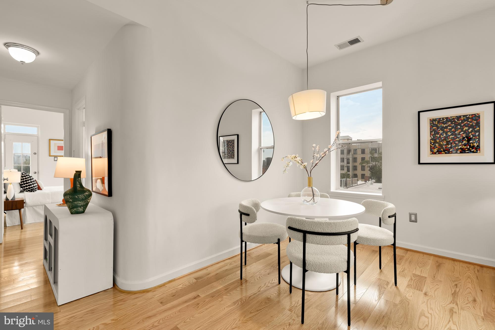 1619 R Street Northwest, Unit 606 Washington, DC 20009 - Photo 4 of 25 a dining room with wooden floor a glass table and chairs