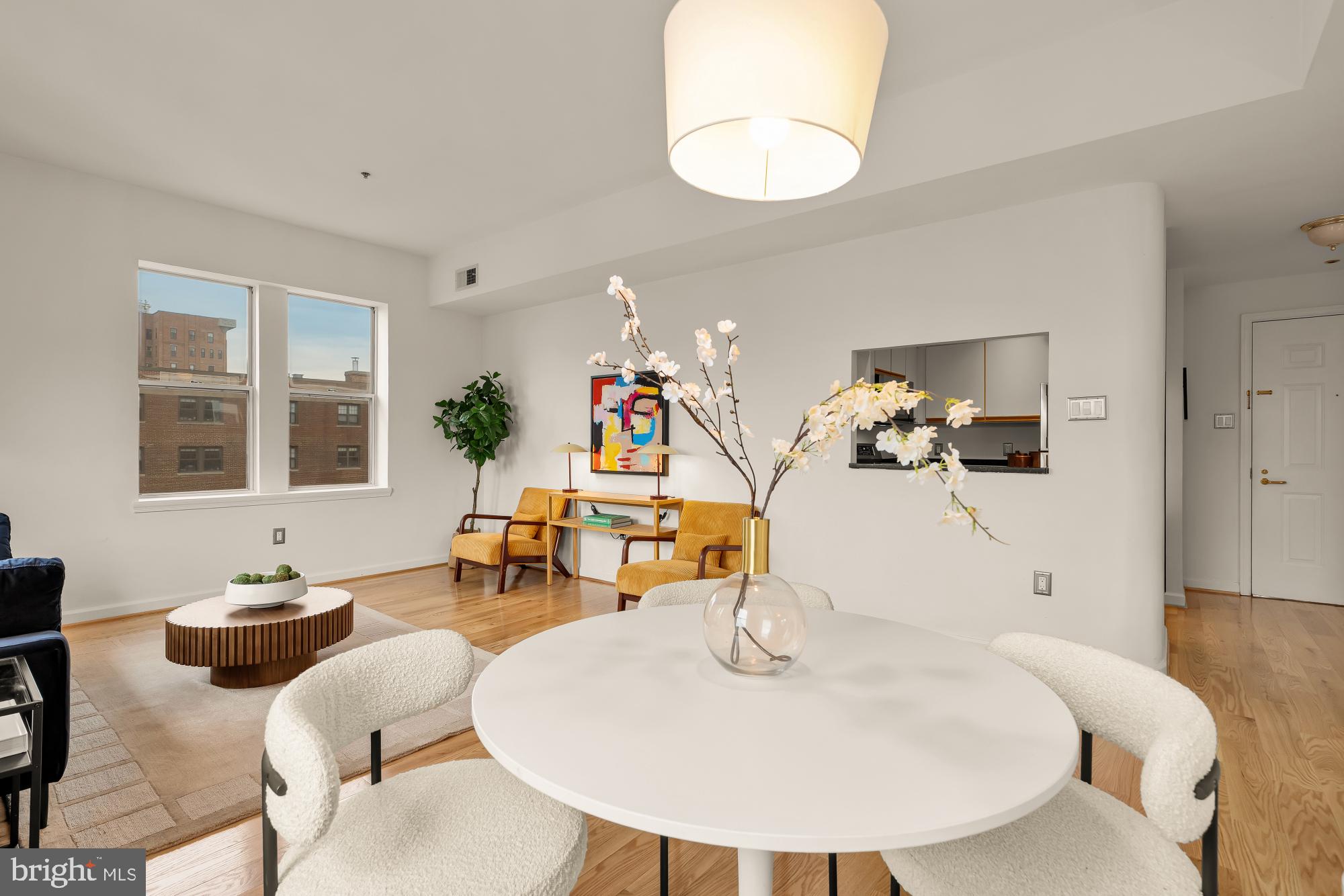 1619 R Street Northwest, Unit 606 Washington, DC 20009 - Photo 5 of 25 a dining room with wooden floor a glass table and chairs