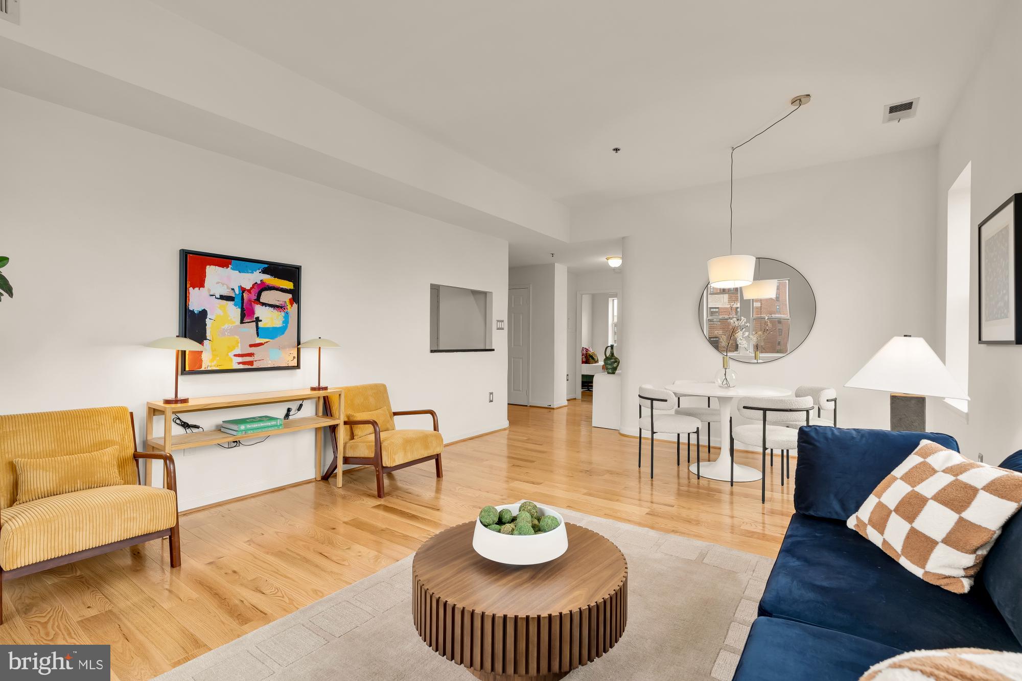 1619 R Street Northwest, Unit 606 Washington, DC 20009 - Photo 9 of 25 a living room with furniture a mirror and a table