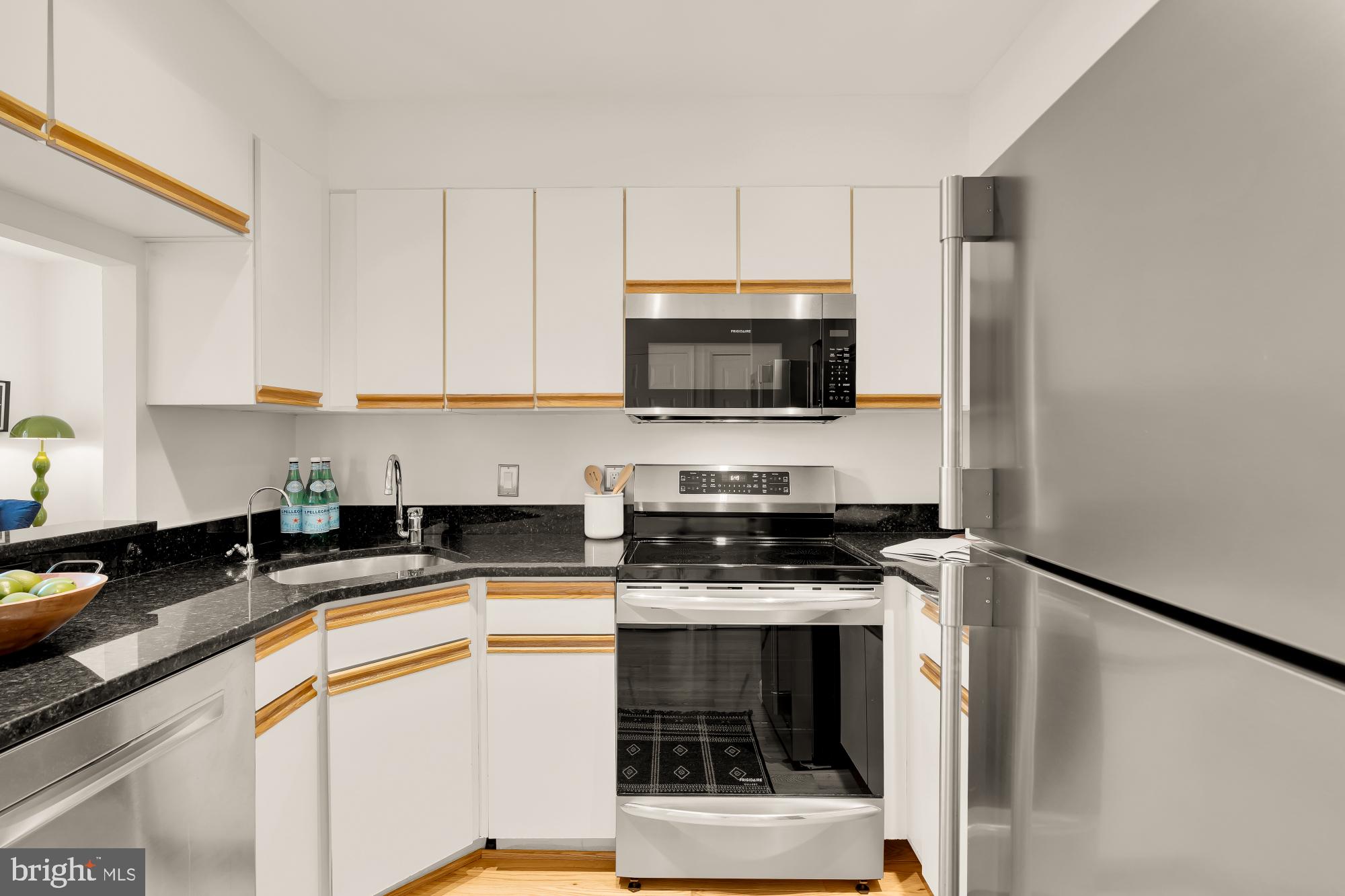1619 R Street Northwest, Unit 606 Washington, DC 20009 - Photo 10 of 25 a kitchen with stainless steel appliances a stove a sink a microwave and refrigerator