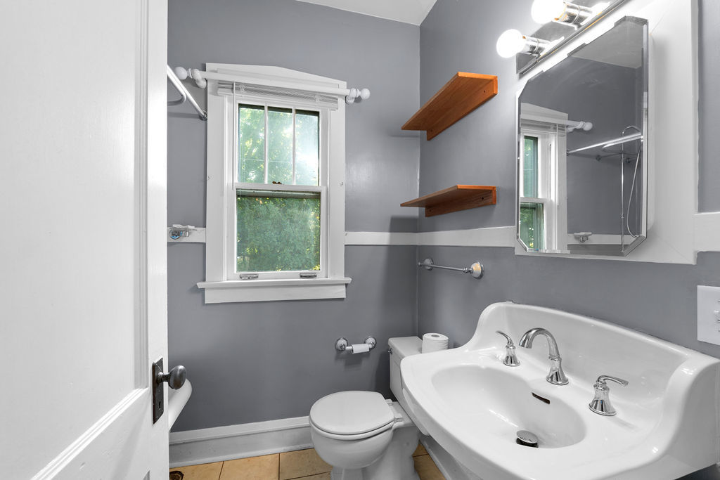 1201 North McKinley Road Lake Forest, IL 60045 - Photo 12 of 17 a bathroom with a sink toilet and a mirror