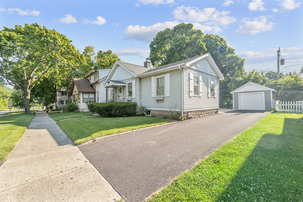 1201 North McKinley Road Lake Forest, IL 60045 - Photo 3 of 17 a front view of a house with a yard and trees