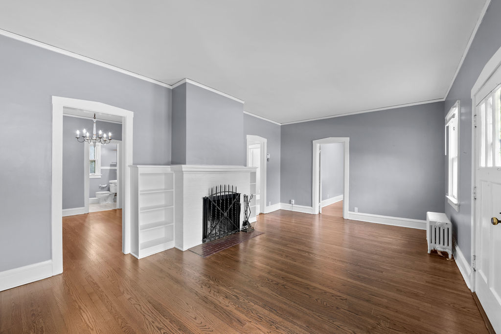 1201 North McKinley Road Lake Forest, IL 60045 - Photo 6 of 17 a view of empty room with wooden floor and fireplace