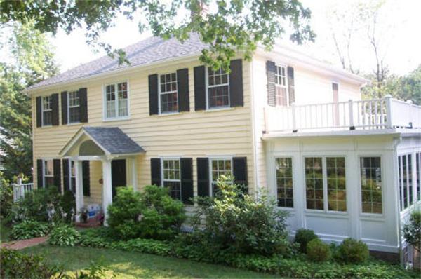 33 Bancroft Road Wellesley, MA 02481 - Photo 1 of 1 a view of a white house next to a yard with potted plants