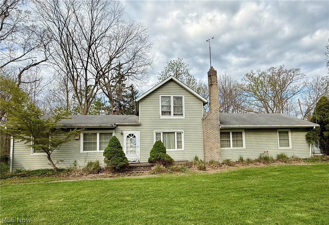 6066 Case Road North Ridgeville, OH 44039 - Photo 1 of 19 Light green siding exterior with a prominent brick chimney