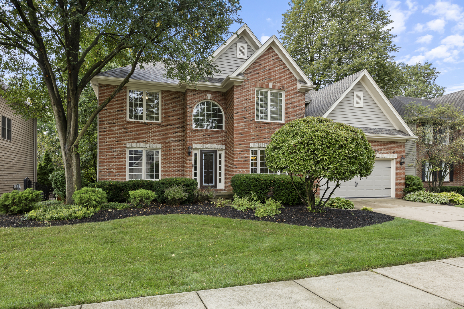 a front view of a house with a garden