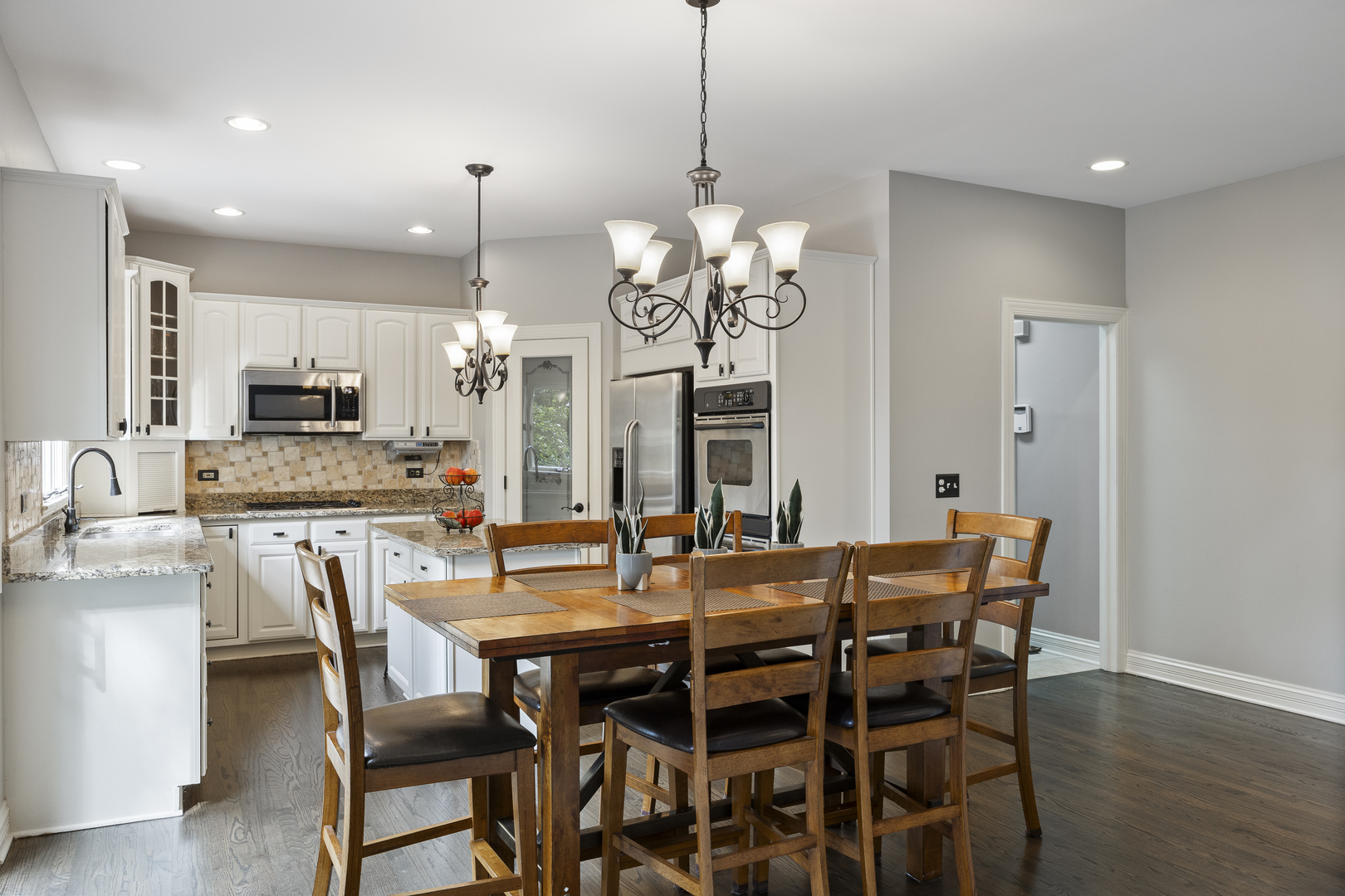 2177 Red Maple Lane Aurora, IL 60502 - Photo 11 of 40 a view of a dining room with furniture a chandelier and wooden floor