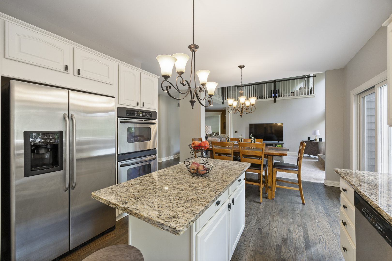 2177 Red Maple Lane Aurora, IL 60502 - Photo 14 of 40 a kitchen with stainless steel appliances granite countertop a refrigerator a sink dishwasher a oven a dining table and chairs with wooden floor