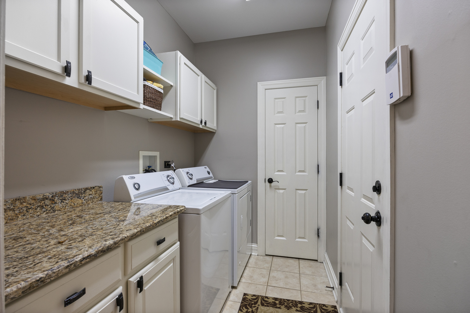 2177 Red Maple Lane Aurora, IL 60502 - Photo 17 of 40 a utility room with granite countertop cabinets washer and dryer
