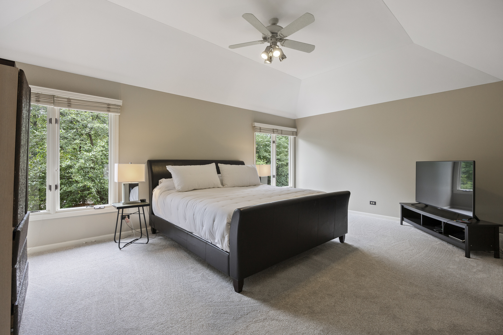 2177 Red Maple Lane Aurora, IL 60502 - Photo 19 of 40 a bedroom with a bed flat screen tv and a large window