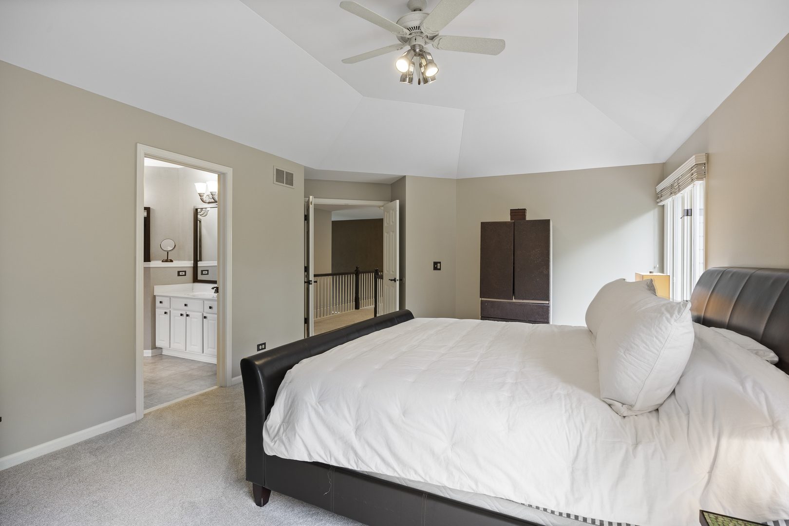 2177 Red Maple Lane Aurora, IL 60502 - Photo 20 of 40 a spacious bedroom with a bed and a chandelier