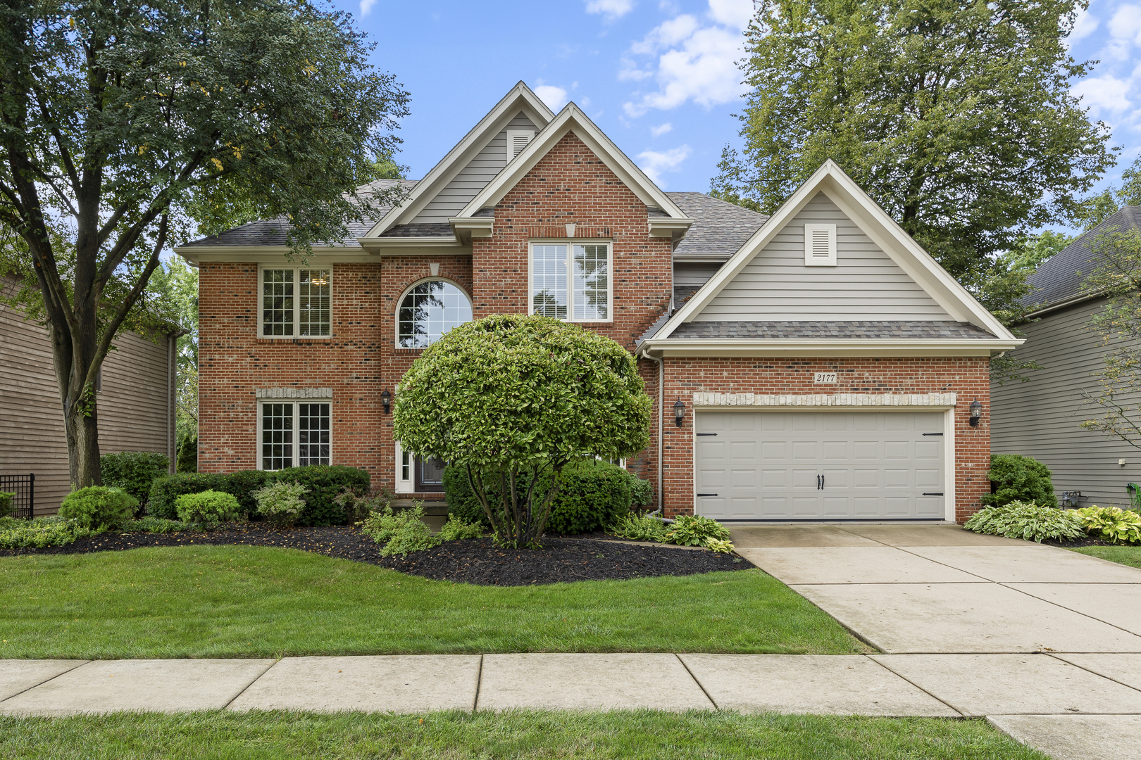 2177 Red Maple Lane Aurora, IL 60502 - Photo 2 of 40 a front view of a house with a yard and garage
