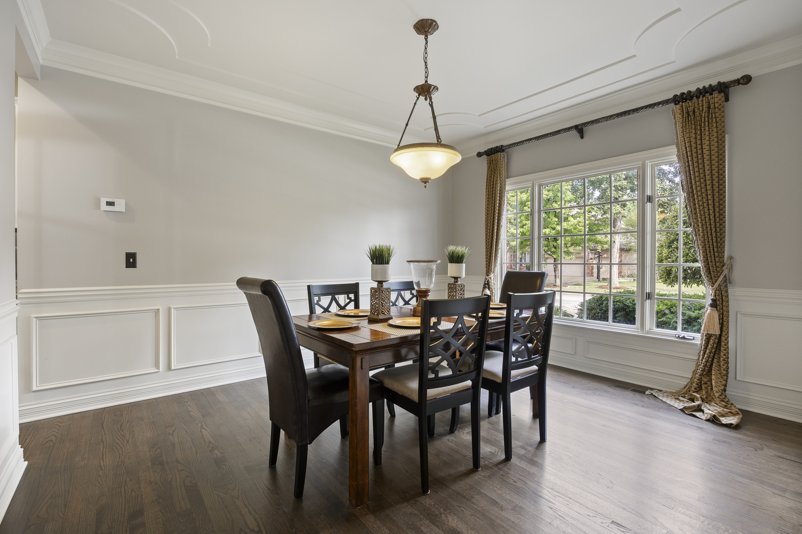 2177 Red Maple Lane Aurora, IL 60502 - Photo 5 of 40 a dining room with wooden floor a chandelier a wooden table and chairs